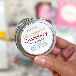 MANDARIN CRANBERRY CANDLE&nbsp;- 100% soy. Non-toxic. Carbon-neutral. Lead-free cotton wick. Made with essential oils and paraben-free fragrance oils for a festive fruit scent. Hand-poured into a travel tin with lid. Handmade by Finny Farm in Georgia. 4oz.&nbsp;