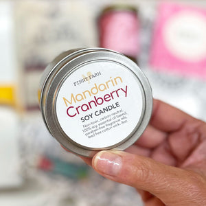 MANDARIN CRANBERRY CANDLE- A subtle sweet scent to uplift the room. 100% soy. Non-toxic. Carbon-neutral. Lead-free cotton wick. Made with essential oils and paraben-free fragrance oils to take them away. Hand-poured into a travel tin with lid. Handmade by Finny Farm in Georgia.