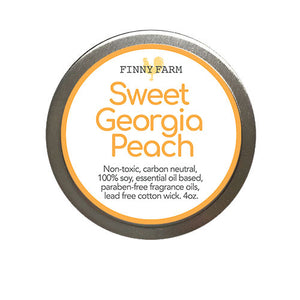 GEORGIA PEACH CANDLE- 100% soy. Non-toxic. Carbon-neutral. Lead-free cotton wick. Made with essential oils and paraben-free fragrance oils for a sweet peach scent. Hand-poured into a travel tin with lid. Handmade by Finny Farm in Georgia.