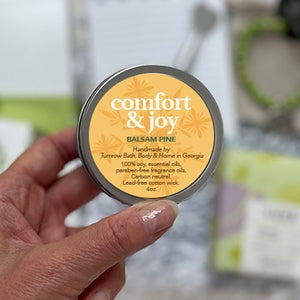 BALSAM PINE SOY CANDLE - A fresh outdoors, pine scent to cozy up the winter season. 100% soy candle. Handmade by Turnrow Bath, Body & Home in Georgia. Comes in cream colored ceramic container with cork lid that can be reused as a planter or holder for treasures. 4 oz. Approx. 20hr burn time. Women-owned small business.