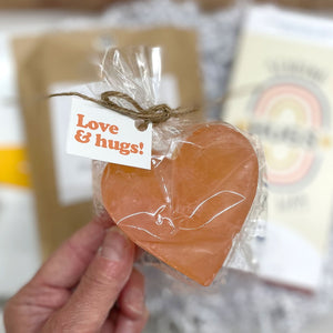 <strong>HEART SOAP</strong>&nbsp;-<span style="color: #666666;" data-mce-style="color: #666666;">&nbsp;Handmade by Soaps by Sam in Georgia. A little happy for the bathroom or kitchen sink. You will be supported a hard-working 13 year old young man, Sam, when you send this Hug Box!</span>