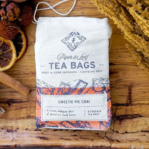 SWEETIE PIE CHAI TEA - A lotta-tea of love for their mug! Lightly spiced, drinkable hug that warms the soul. Filled with joy, you are ready to repaint these memories time and again as you take each sip of Sweetie Pie Chai. Ingredients: Sweet Potato, Cinnamon, Tulsi, Ginger, Licorice Root, Clove, Cassia Oil, Vanilla. Caffeine-free. Handcrafted by Piper and Leaf in Alabama. Packaged in muslin bags with 9 pyramid sachets of tea ready to brew. Caffeine-free. 