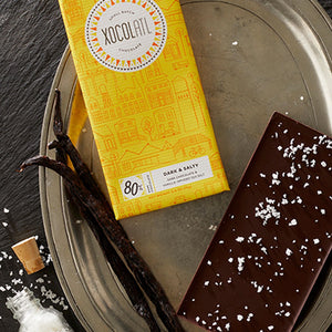 DARK & SALTY CHOCOLATE BAR - The vanilla-infused sea salt sprinkled on the back brings out a little magic from this Ugandan cacao with subtle flavors of cinnamon chocolate cake. Ingredients: Organic Ugandan Cacao, Organic Cane Sugar, Vanilla Bean-Infused Sea Salt. Made by xocolatl in Georgia. Photo credit: xocolatl