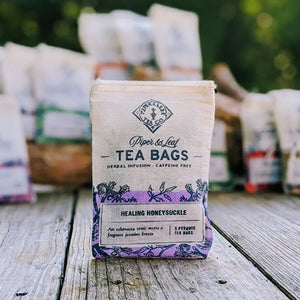 HEALING HONEYSUCKLE TEA - A light, tonic, caffeine-free, artisan tea blended with all-natural ingredients such as echinacea, jasmine, lemongrass and mint. This tea is handmade by Piper and Leaf in Alabama. 9 silky pyramid sachets ready to brew.